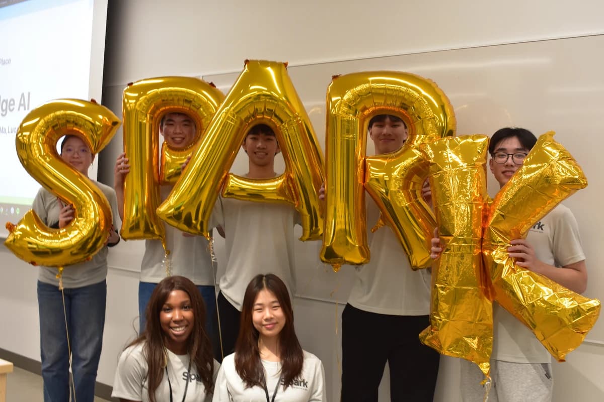 WDS members celebrating together with gold SPARK balloons